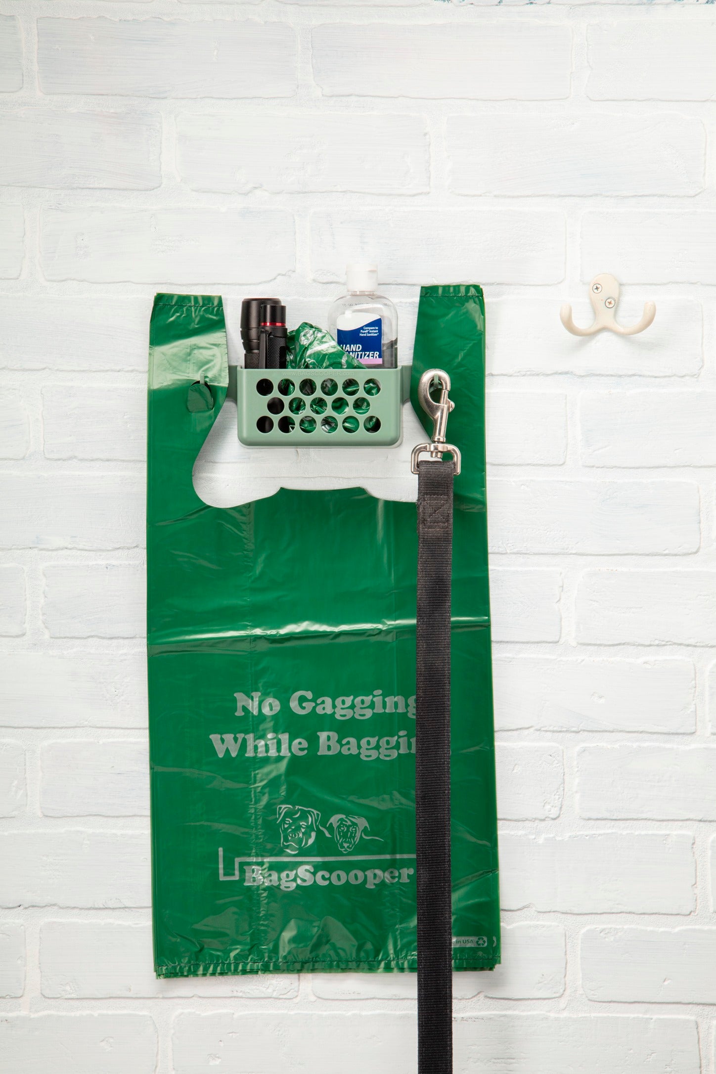 Bag Scooper wall station with leash hanging and waste bags loaded